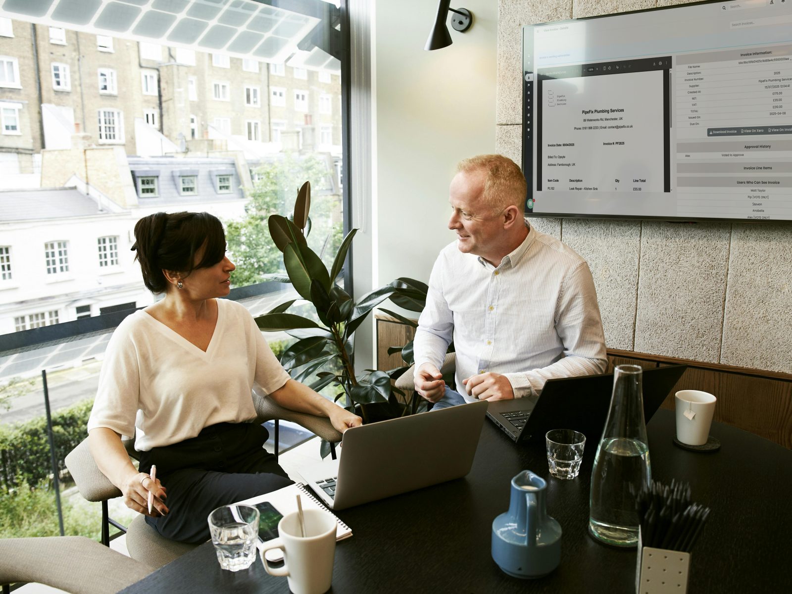 Two of the finance team working through supplier invoices in Opsyte