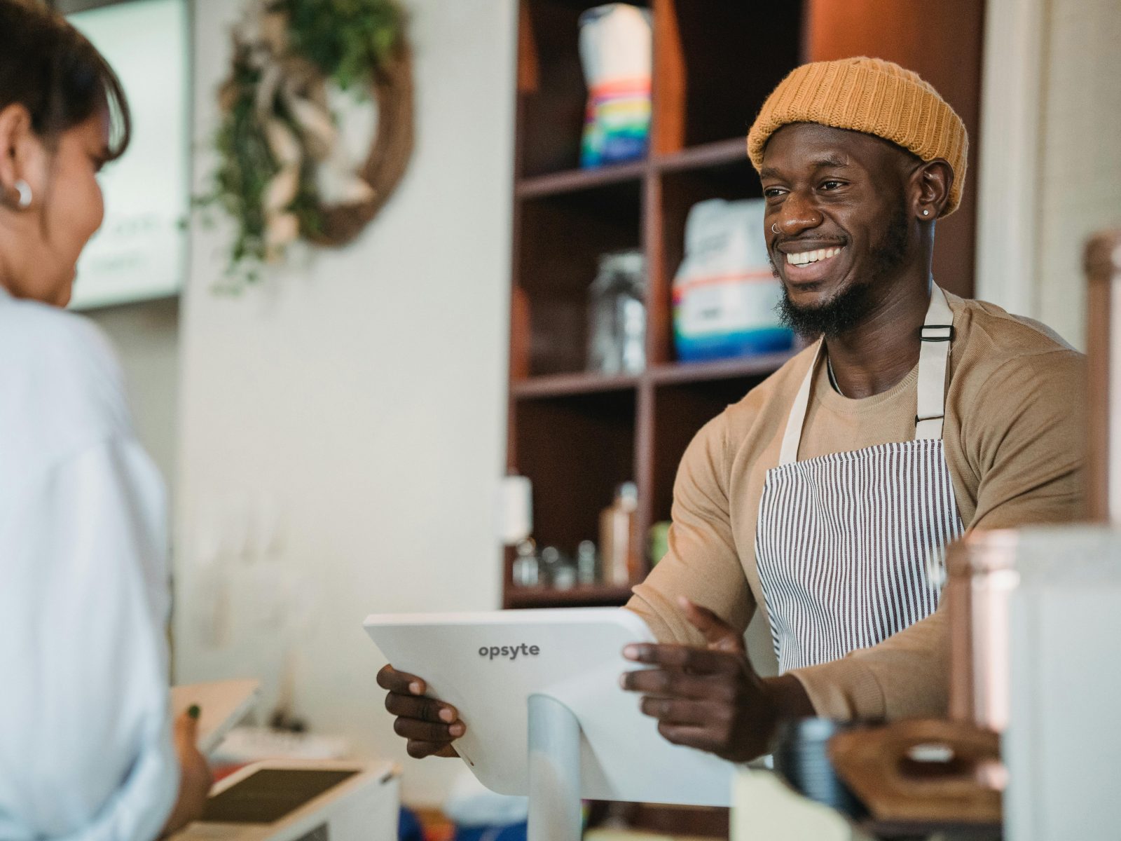 A barista taking an order at an Opsyte till